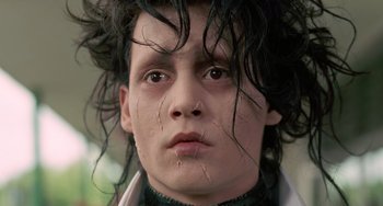 Movie still from “Edward Scissorhands” (1990), directed by Tim Burton – A person wearing a wig; Close Up shot, Low angle