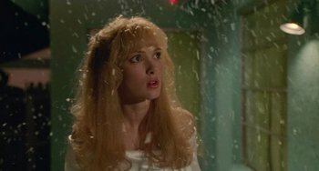 Movie still from “Edward Scissorhands” (1990), directed by Tim Burton – A woman standing in front of a window; Close Up shot, Over the shoulder angle