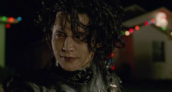 Movie still from “Edward Scissorhands” (1990), directed by Tim Burton – A person wearing a costume; Close Up shot, Low angle