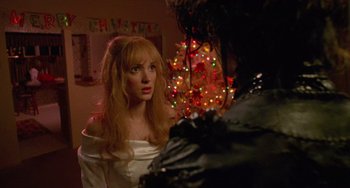 Movie still from “Edward Scissorhands” (1990), directed by Tim Burton – A woman in a white dress looking at a man in a black suit; Close Up shot, Over the shoulder angle