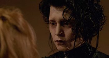 Movie still from “Edward Scissorhands” (1990), directed by Tim Burton – A person wearing a black shirt; Close Up shot, Low angle