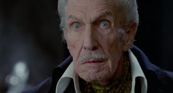 Movie still from “Edward Scissorhands” (1990), directed by Tim Burton – An old man with blue eyes stares at the camera; Close Up shot, Low angle