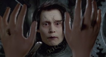 Movie still from “Edward Scissorhands” (1990), directed by Tim Burton – A person wearing a black collar; Close Up shot, Low angle