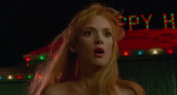 Movie still from “Edward Scissorhands” (1990), directed by Tim Burton – A woman with long blonde hair looking surprised; Close Up shot, Low angle