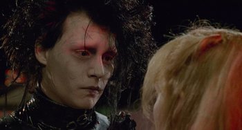 Movie still from “Edward Scissorhands” (1990), directed by Tim Burton – A person wearing a costume; Close Up shot, Over the shoulder angle