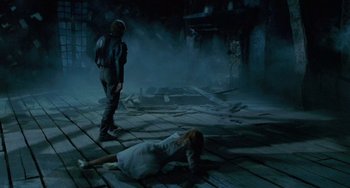 Movie still from “Edward Scissorhands” (1990), directed by Tim Burton – A man and a woman are laying on the ground; Wide shot, High angle