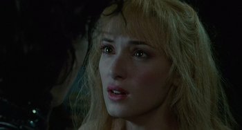 Movie still from “Edward Scissorhands” (1990), directed by Tim Burton – A woman's face with green eyes; Close Up shot, Over the shoulder angle