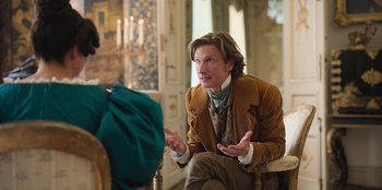 Movie still from “Ehrengard: The Art of Seduction” (2023), directed by Bille August – A man in a brown jacket talking to a woman; Medium shot, Over the shoulder angle
