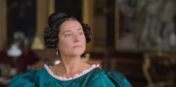 Movie still from “Ehrengard: The Art of Seduction” (2023), directed by Bille August – A person wearing a dress; Close Up shot, Low angle