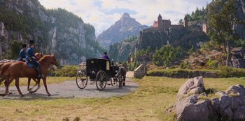 Movie still from “Ehrengard: The Art of Seduction” (2023), directed by Bille August – A horse drawn carriage traveling down a road near mountains; Extreme Wide shot, High angle