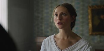 Movie still from “Ehrengard: The Art of Seduction” (2023), directed by Bille August – A woman in a white shirt looking to her left; Close Up shot, Low angle