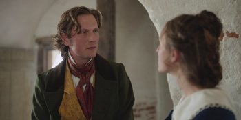 Movie still from “Ehrengard: The Art of Seduction” (2023), directed by Bille August – A man and a woman are talking in a room; Close Up shot, Over the shoulder angle