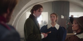 Movie still from “Ehrengard: The Art of Seduction” (2023), directed by Bille August – A man and a woman standing next to each other; Medium shot, Over the shoulder angle