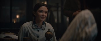 Movie still from “Eiffel” (2021), directed by Martin Bourboulon – A woman sitting in front of an ornate vase; Medium shot, Over the shoulder angle