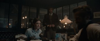 Movie still from “Eiffel” (2021), directed by Martin Bourboulon – A man and a woman standing in front of a lamp; Medium shot, Over the shoulder angle