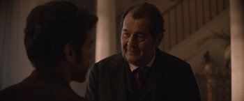 Movie still from “Eiffel” (2021), directed by Martin Bourboulon – An older man wearing a suit talking to a younger man; Close Up shot, Over the shoulder angle