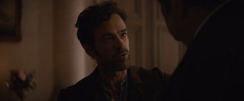 Movie still from “Eiffel” (2021), directed by Martin Bourboulon – A person wearing a suit; Close Up shot, Over the shoulder angle