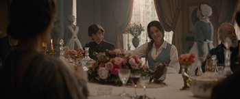 Movie still from “Eiffel” (2021), directed by Martin Bourboulon – A man and a woman sitting at a dinner table; Medium shot, Over the shoulder angle