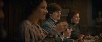 Movie still from “Eiffel” (2021), directed by Martin Bourboulon – A man and a woman sitting at a table with drinks; Medium shot, Over the shoulder angle