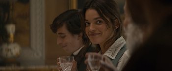 Movie still from “Eiffel” (2021), directed by Martin Bourboulon – A woman and a man are holding glasses of water; Close Up shot, Over the shoulder angle
