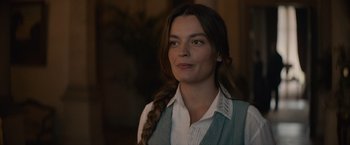 Movie still from “Eiffel” (2021), directed by Martin Bourboulon – A woman wearing a white shirt and a blue vest; Close Up shot, Over the shoulder angle