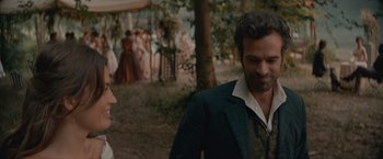 Movie still from “Eiffel” (2021), directed by Martin Bourboulon – A man and a woman standing in front of a tree; Medium shot, Over the shoulder angle