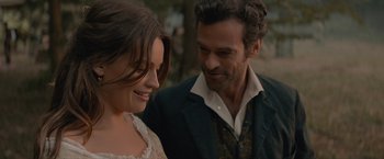 Movie still from “Eiffel” (2021), directed by Martin Bourboulon – A man and a woman standing next to each other; Close Up shot, Over the shoulder angle