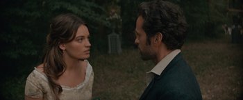 Movie still from “Eiffel” (2021), directed by Martin Bourboulon – A man and a woman standing next to each other in a field; Close Up shot, Over the shoulder angle