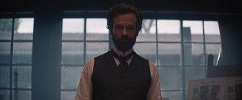 Movie still from “Eiffel” (2021), directed by Martin Bourboulon – A man with a beard wearing a vest and a tie; Medium shot, Low angle