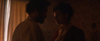 Movie still from “Eiffel” (2021), directed by Martin Bourboulon – A man and a woman standing next to each other in the dark; Close Up shot, Over the shoulder angle