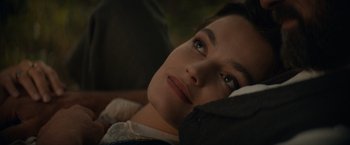 Movie still from “Eiffel” (2021), directed by Martin Bourboulon – A person laying on a bed; Close Up shot, High angle