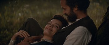 Movie still from “Eiffel” (2021), directed by Martin Bourboulon – A man and a woman sitting next to each other; Medium shot, High angle