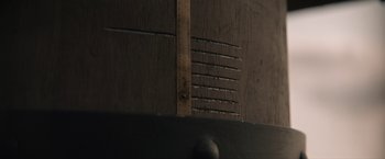 Movie still from “Eiffel” (2021), directed by Martin Bourboulon – View of a ruler on a piece of wood; Extreme Close Up shot, Low angle