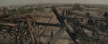 Movie still from “Eiffel” (2021), directed by Martin Bourboulon – A group of people standing on top of a wooden structure; Extreme Wide shot, High angle