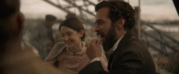 Movie still from “Eiffel” (2021), directed by Martin Bourboulon – A man and a woman sitting at a table; Close Up shot, Over the shoulder angle