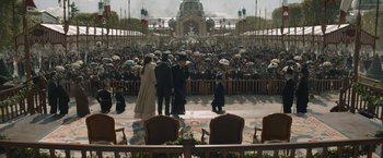 Movie still from “Eiffel” (2021), directed by Martin Bourboulon – A group of people standing in front of a crowd; Extreme Wide shot, High angle