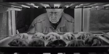 Movie still from “El Conde” (2023), directed by Pablo Larraín – An old man looking at some food in a pan; Close Up shot, Over the shoulder angle