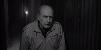 Movie still from “El Conde” (2023), directed by Pablo Larraín – An older man in a jacket looking at the camera; Medium shot, Low angle