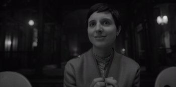 Movie still from “El Conde” (2023), directed by Pablo Larraín – Black and white photograph of a woman smiling; Close Up shot, High angle