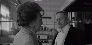 Movie still from “El Conde” (2023), directed by Pablo Larraín – An older man and a younger woman in a kitchen; Close Up shot, Over the shoulder angle