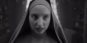 Movie still from “El Conde” (2023), directed by Pablo Larraín – A woman wearing a nun's head covering; Close Up shot, Low angle