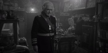 Movie still from “El Conde” (2023), directed by Pablo Larraín – An old man dressed in a military uniform; Medium shot, Over the shoulder angle