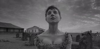 Movie still from “El Conde” (2023), directed by Pablo Larraín – A black and white photo of a woman looking up; Close Up shot, Low angle