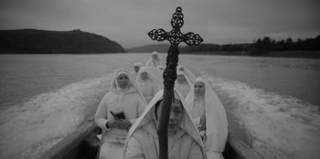 Movie still from “El Conde” (2023), directed by Pablo Larraín – A group of nuns on a boat in a body of water; Wide shot, High angle