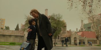 Movie still from “El Conde” (2023), directed by Pablo Larraín – A woman and a boy walking down a street; Medium shot, Low angle