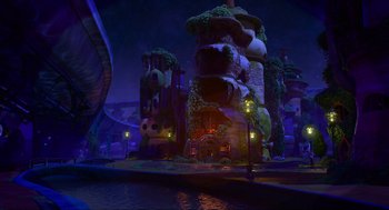 Movie still from “Elemental” (2023), directed by Peter Sohn – A night scene of a building with lights on; Extreme Wide shot, High angle