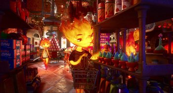 Movie still from “Elemental” (2023), directed by Peter Sohn – A woman is standing next to a store filled with lots of food; Wide shot, Over the shoulder angle