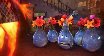 Movie still from “Elemental” (2023), directed by Peter Sohn – A group of glass vases with flowers in them on a table; Wide shot, High angle