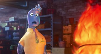 Movie still from “Elemental” (2023), directed by Peter Sohn – A blue man in a yellow shirt and a tie; Close Up shot, Over the shoulder angle