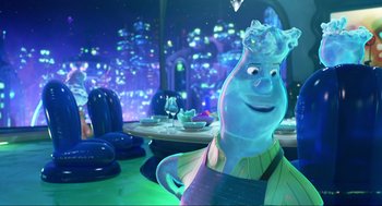 Movie still from “Elemental” (2023), directed by Peter Sohn – A character in a restaurant is smiling for the camera; Medium shot, Over the shoulder angle